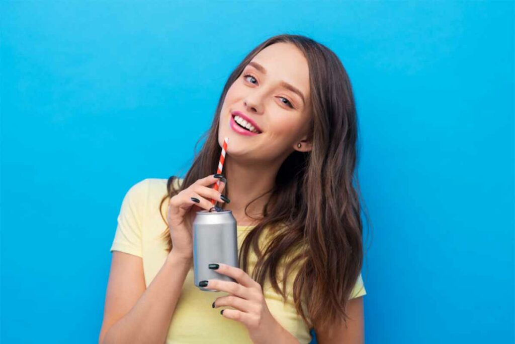 Woman drinking a cannabis beverage with a straw