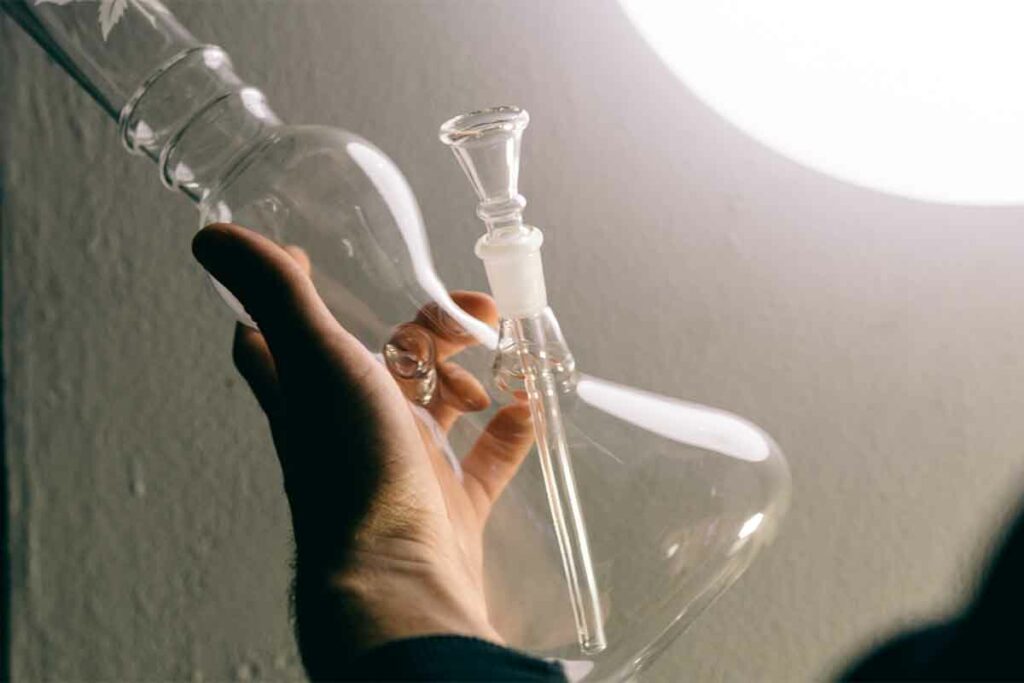 Hand holding a clean glass bong